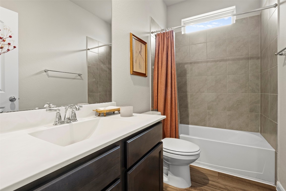 14239 Volcano Perch Drive Conroe, TX 77384 - Photo 6 of 39 a bathroom with a sink a toilet and shower