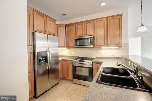 a kitchen with a refrigerator stove and sink