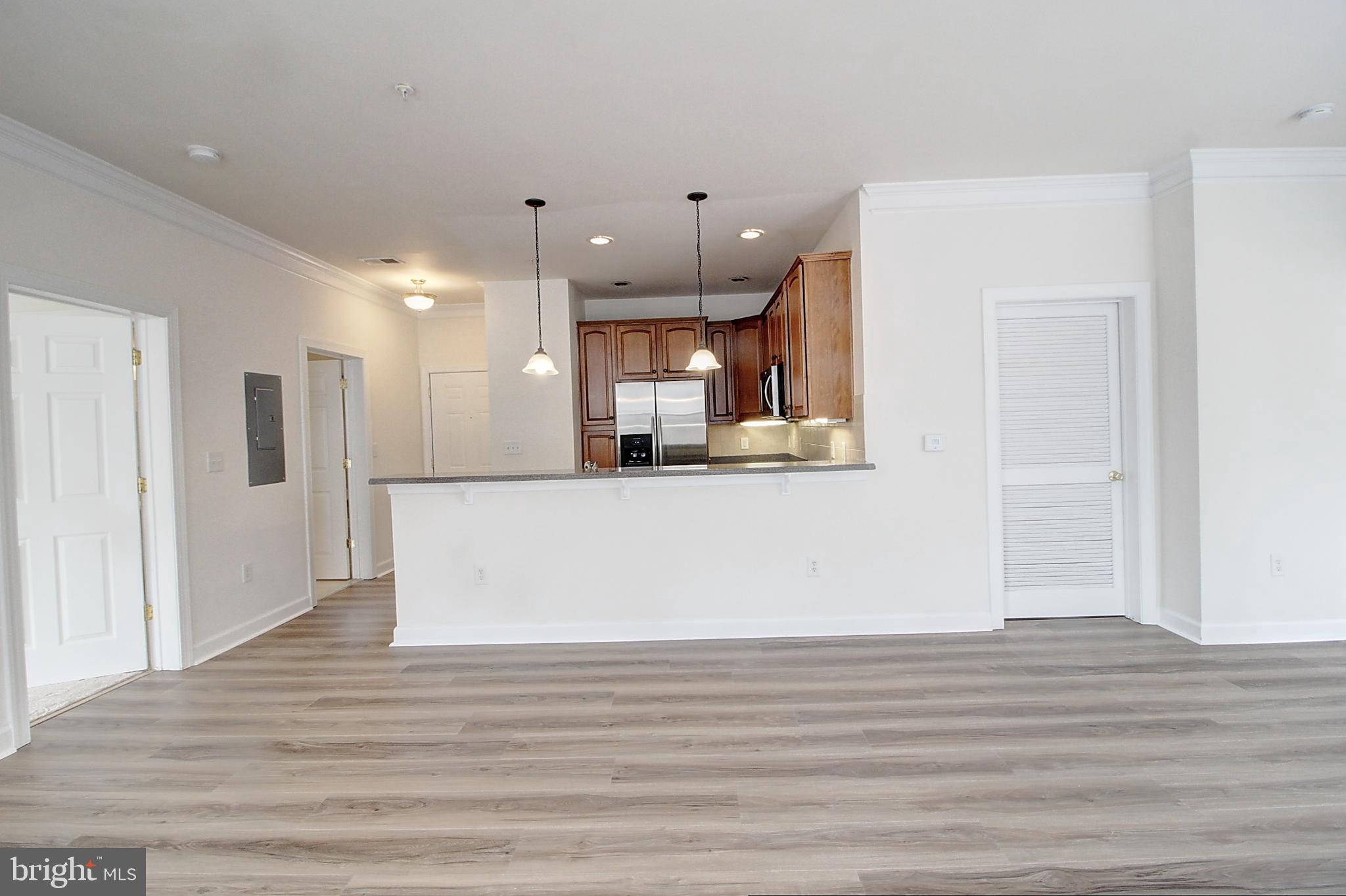35 East All Saints Street, Unit 321 Frederick, MD 21701 - Photo 5 of 17 a view of a kitchen and an empty room