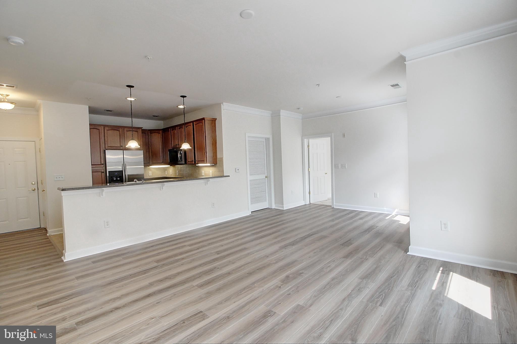 35 East All Saints Street, Unit 321 Frederick, MD 21701 - Photo 6 of 17 a view of kitchen and wooden floor