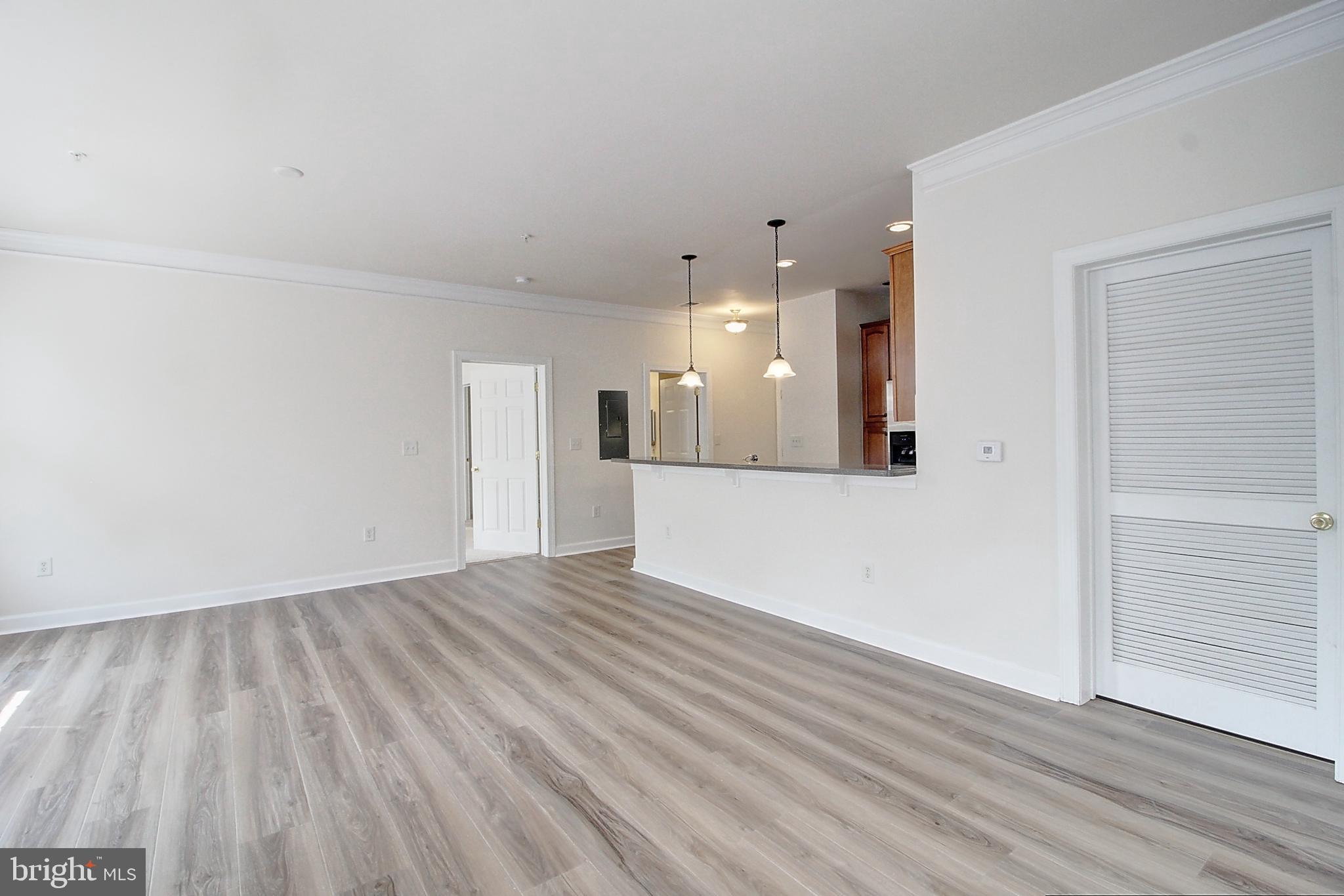 35 East All Saints Street, Unit 321 Frederick, MD 21701 - Photo 8 of 17 an empty room with wooden floor and windows