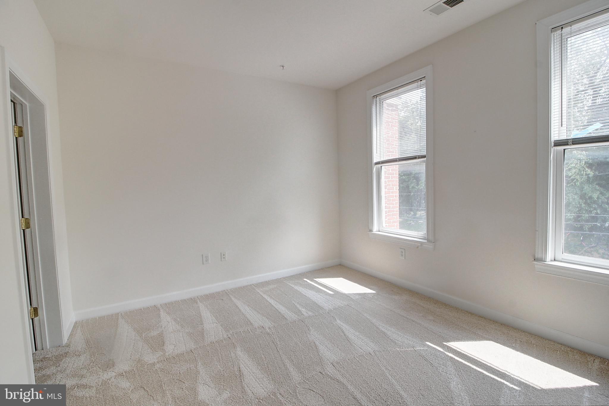 35 East All Saints Street, Unit 321 Frederick, MD 21701 - Photo 10 of 17 an empty room with windows