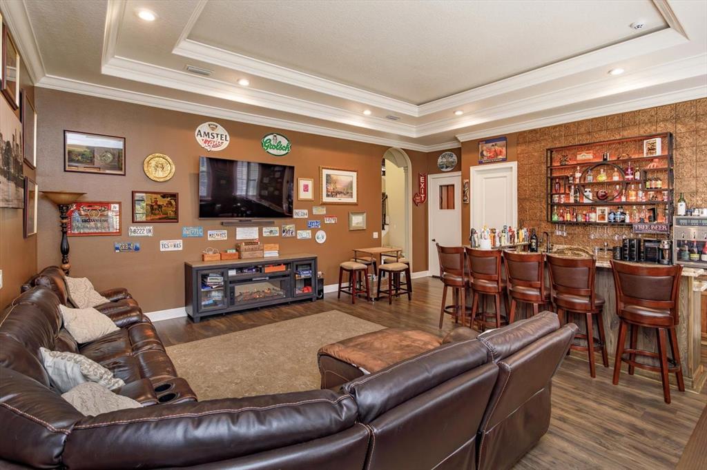 5719 Emerson Pointe Way Orlando, FL 32819 - Photo 16 of 50 a living room with furniture and a flat screen tv