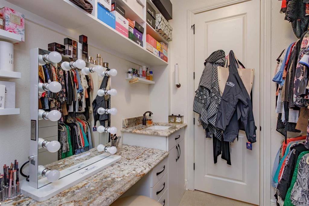 5719 Emerson Pointe Way Orlando, FL 32819 - Photo 24 of 50 a view of walk in closet with clothes and shoes