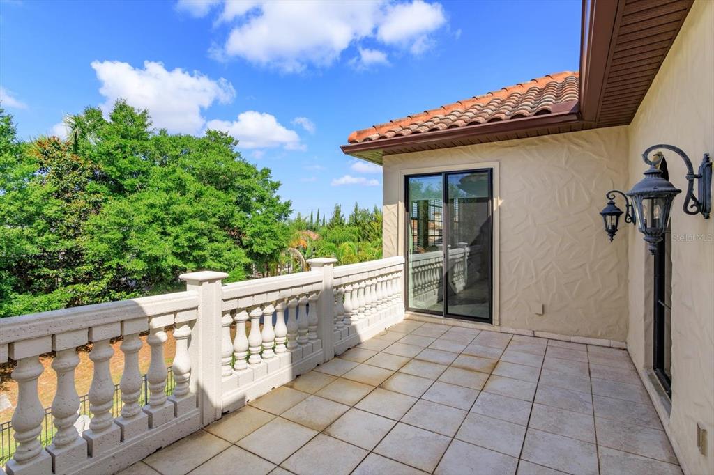 5719 Emerson Pointe Way Orlando, FL 32819 - Photo 26 of 50 a view of a balcony with wooden fence
