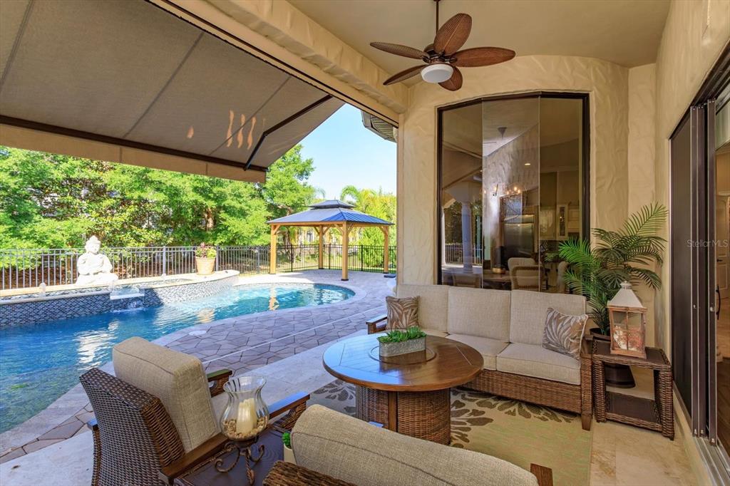 5719 Emerson Pointe Way Orlando, FL 32819 - Photo 29 of 50 a living room with furniture and a large window