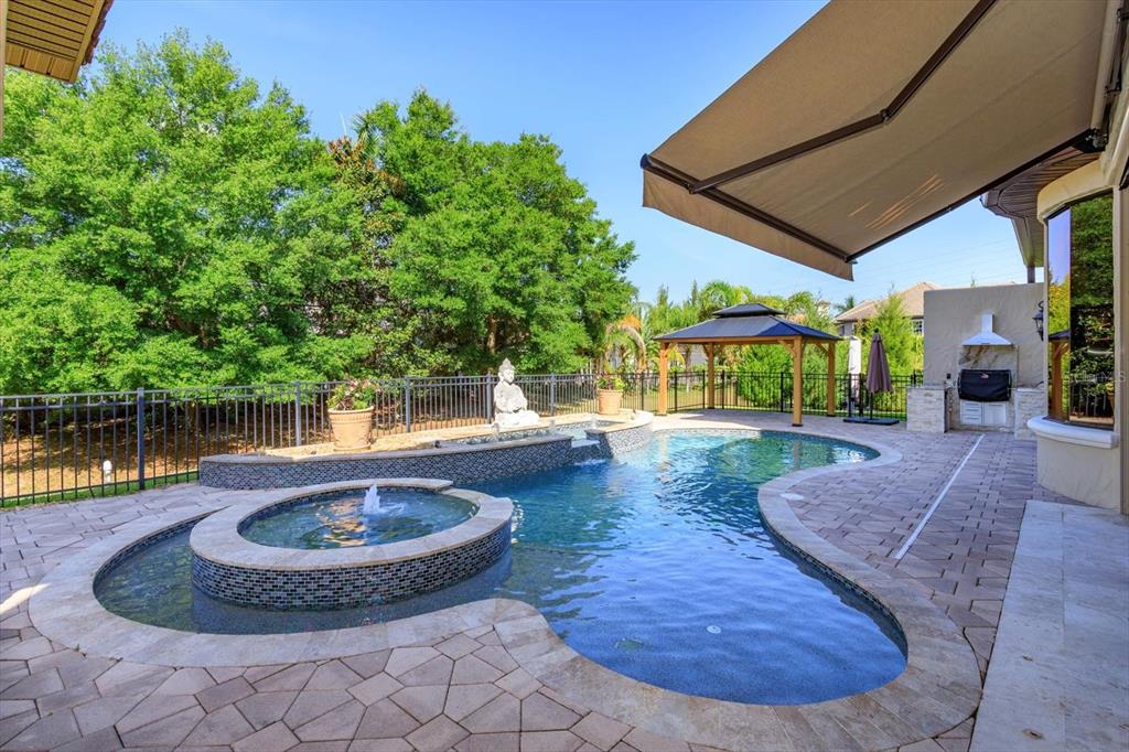 5719 Emerson Pointe Way Orlando, FL 32819 - Photo 30 of 50 a view of a swimming pool with a patio