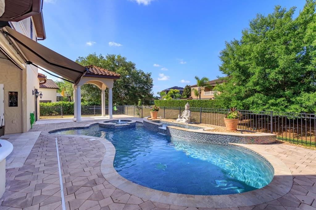 5719 Emerson Pointe Way Orlando, FL 32819 - Photo 31 of 50 a view of a swimming pool with a patio