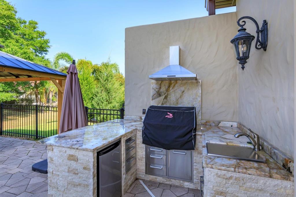 5719 Emerson Pointe Way Orlando, FL 32819 - Photo 34 of 50 a view of a table and chairs in the patio