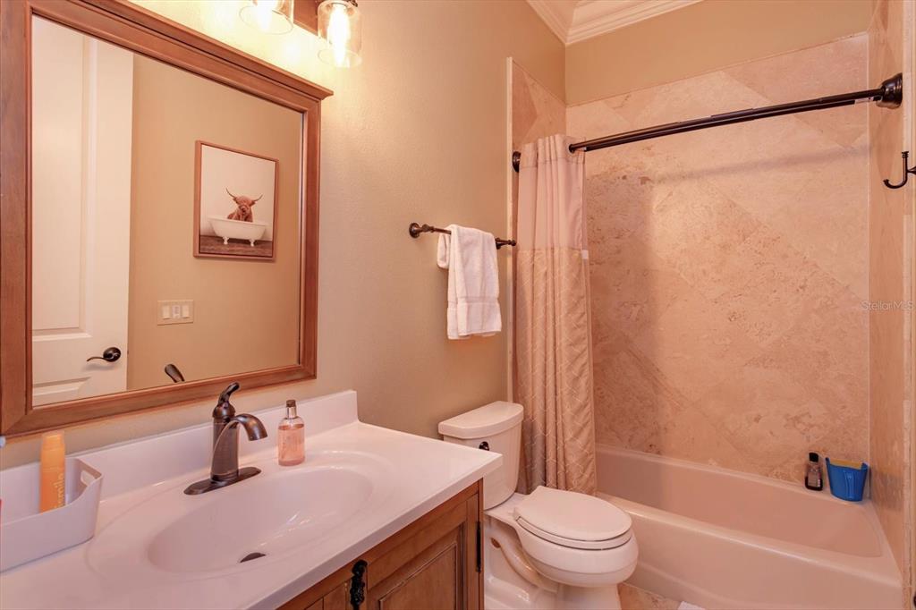 5719 Emerson Pointe Way Orlando, FL 32819 - Photo 41 of 50 a bathroom with a sink a toilet and a mirror