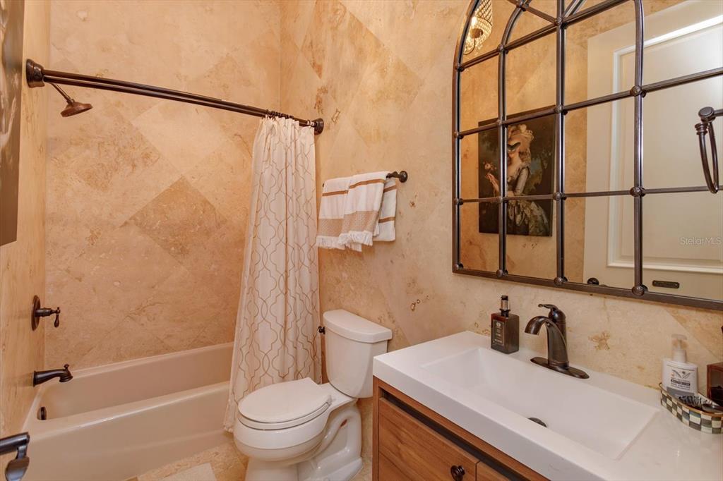 5719 Emerson Pointe Way Orlando, FL 32819 - Photo 43 of 50 a bathroom with a granite countertop sink toilet and shower