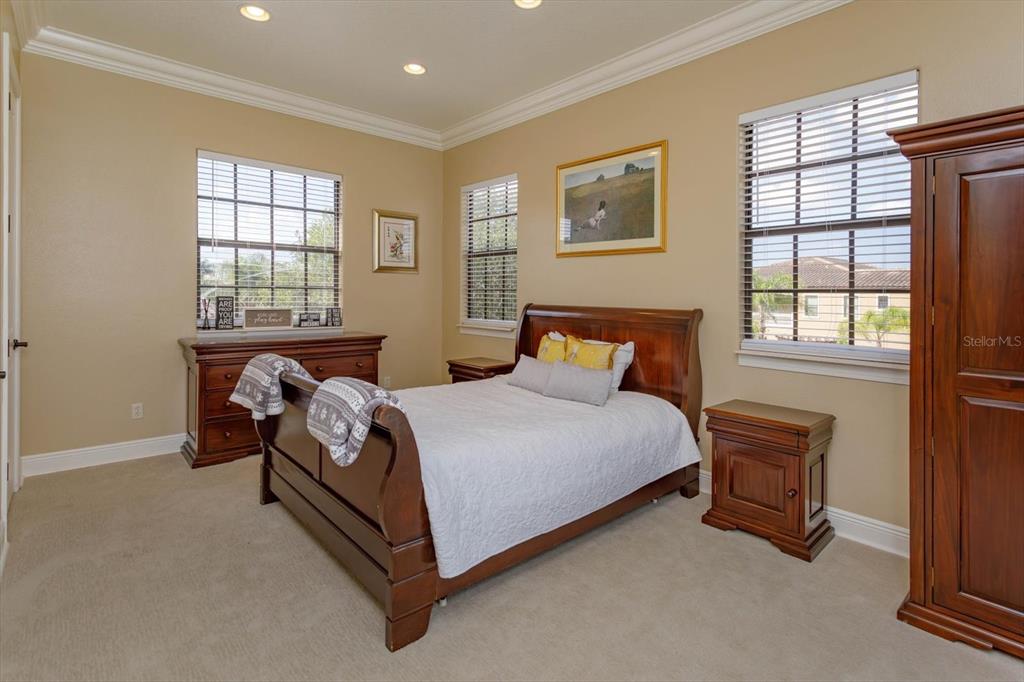 5719 Emerson Pointe Way Orlando, FL 32819 - Photo 44 of 50 a bedroom with a bed and window