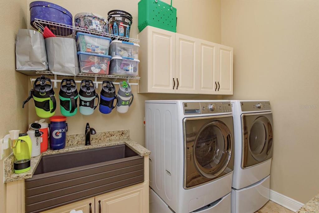 5719 Emerson Pointe Way Orlando, FL 32819 - Photo 45 of 50 a utility room with dryer and washer