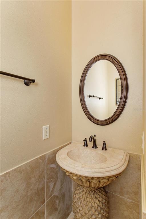5719 Emerson Pointe Way Orlando, FL 32819 - Photo 50 of 50 a bathroom with a sink and a mirror
