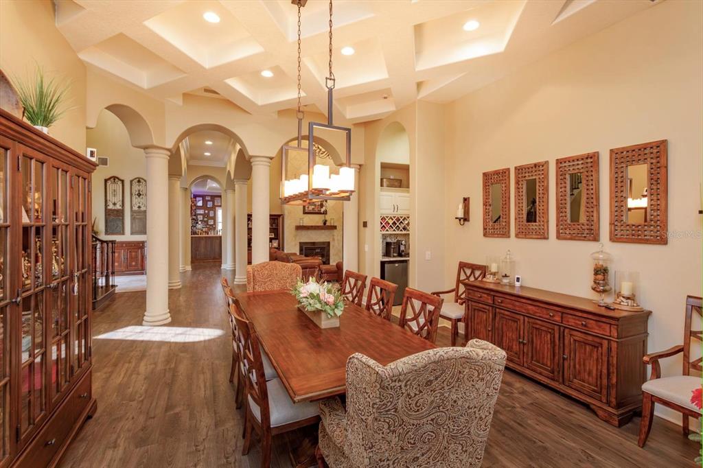 5719 Emerson Pointe Way Orlando, FL 32819 - Photo 7 of 50 a view of a dining room with furniture and chandelier