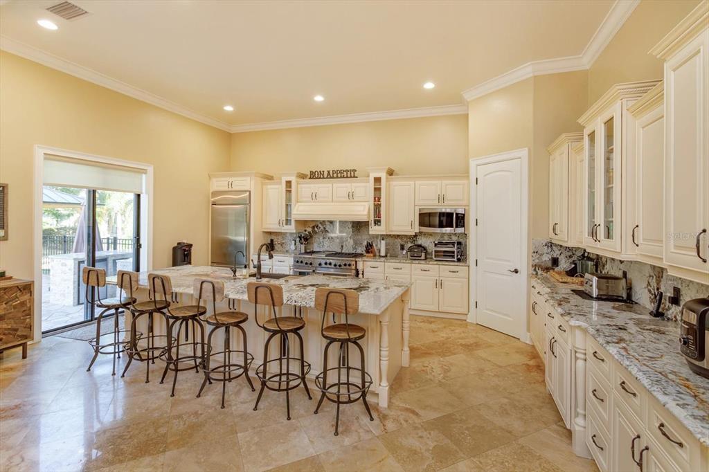 5719 Emerson Pointe Way Orlando, FL 32819 - Photo 8 of 50 a large kitchen with a table and chairs