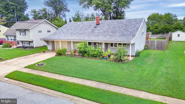 a front view of a house with a garden and yard