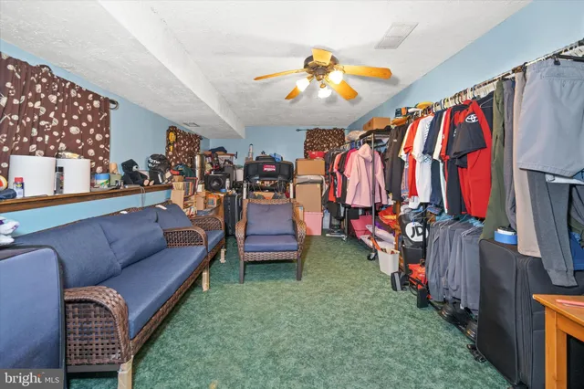 a living room with furniture a baby crib and a couch