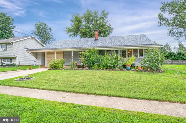 a front view of a house with a garden and plants