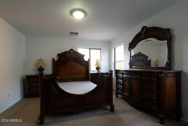 a living room with a table chairs and a wooden floor