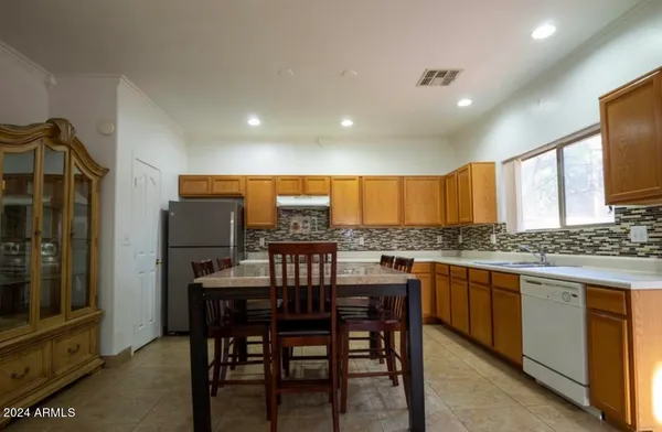 a kitchen with a table and chairs in it