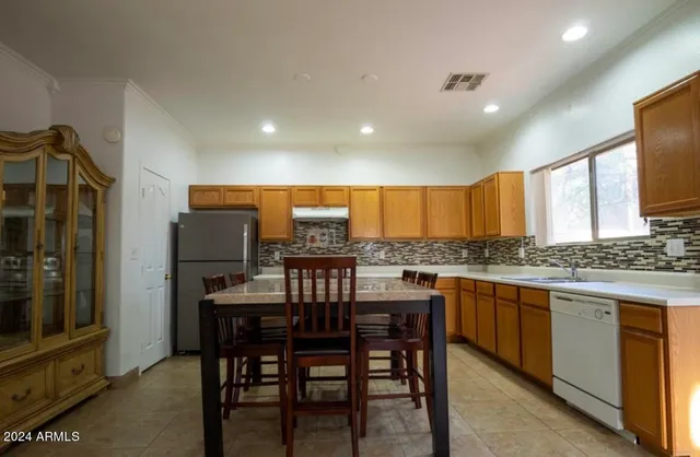 a kitchen with a table and chairs in it