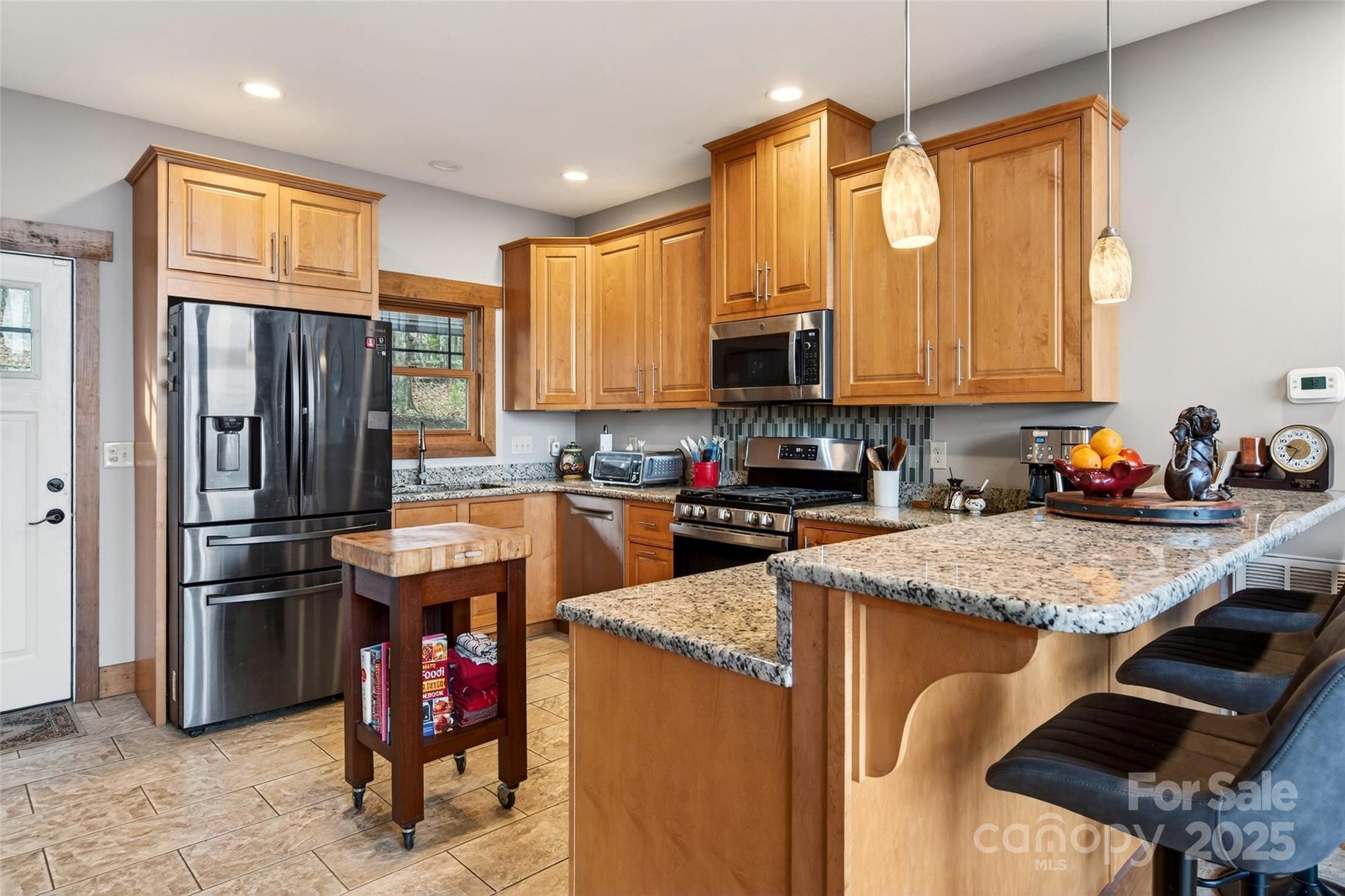 242 Lakeview Trail Nebo, NC 28761 - Photo 12 of 46 a kitchen with stainless steel appliances granite countertop a refrigerator stove and sink