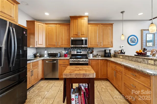 a kitchen with granite countertop a stove top oven sink and cabinets