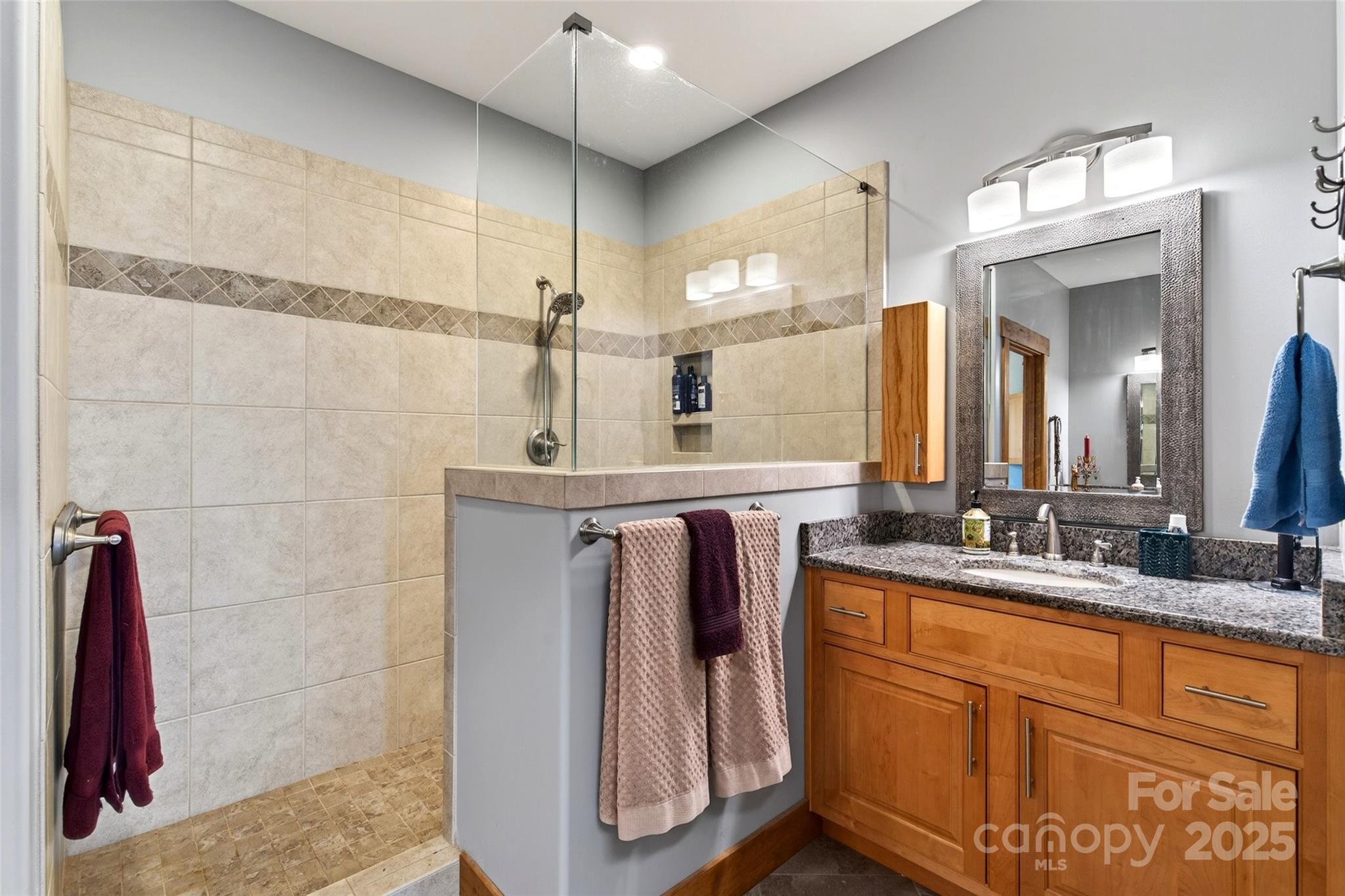 242 Lakeview Trail Nebo, NC 28761 - Photo 21 of 46 a bathroom with a double vanity sink and a mirror