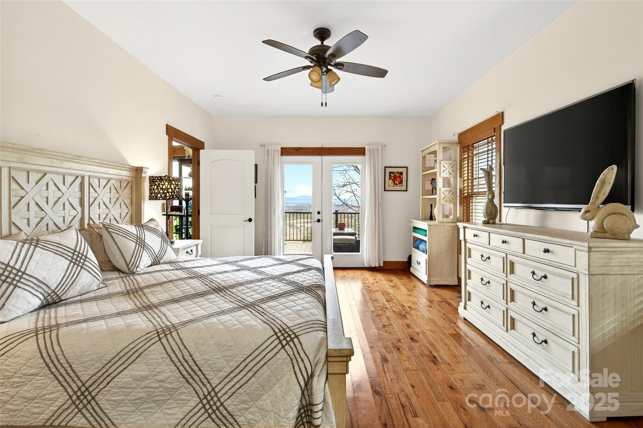 242 Lakeview Trail Nebo, NC 28761 - Photo 23 of 46 a spacious bedroom with a bed and a flat screen tv