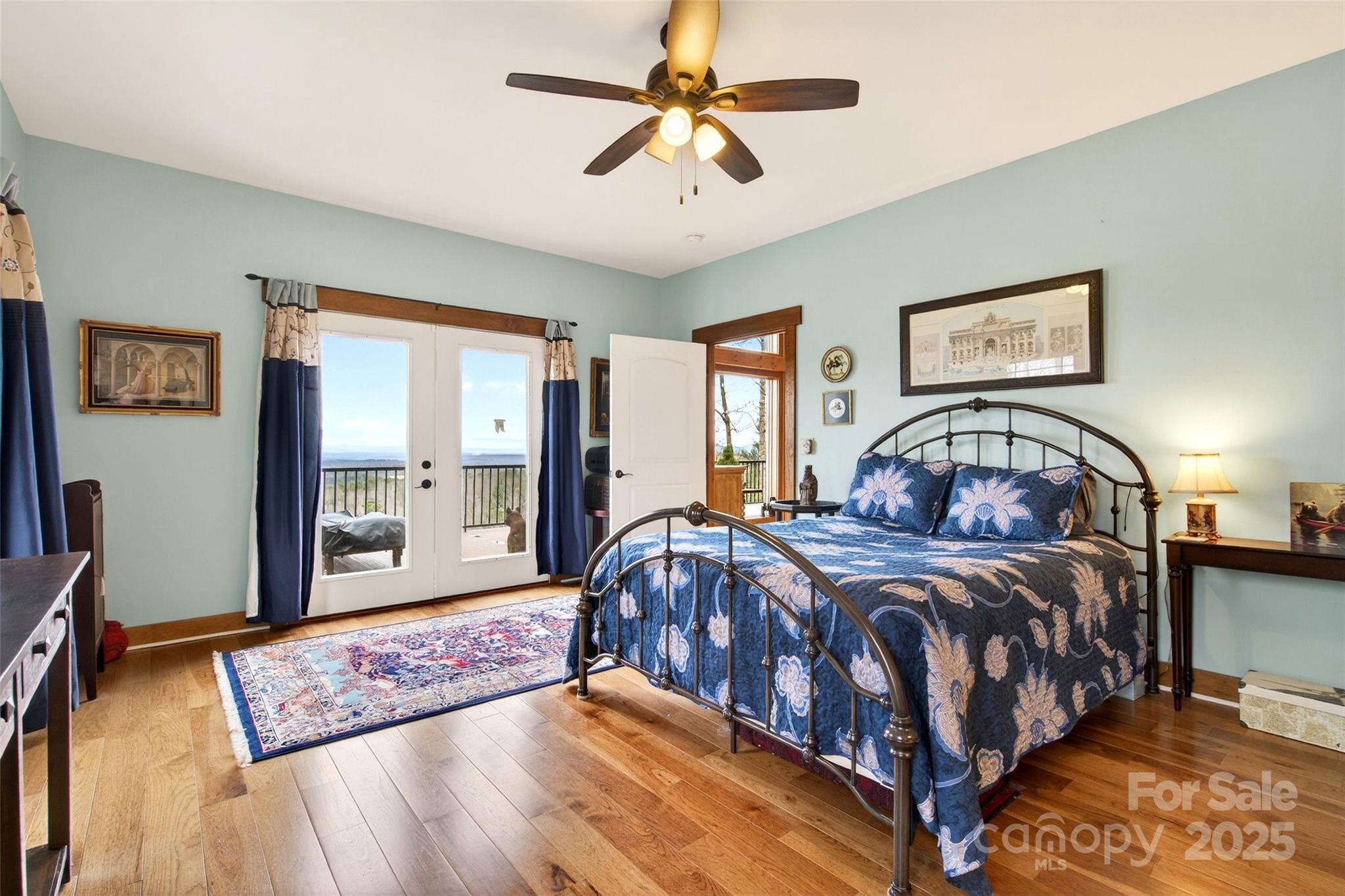 242 Lakeview Trail Nebo, NC 28761 - Photo 25 of 46 a bedroom with a large bed and a chandelier