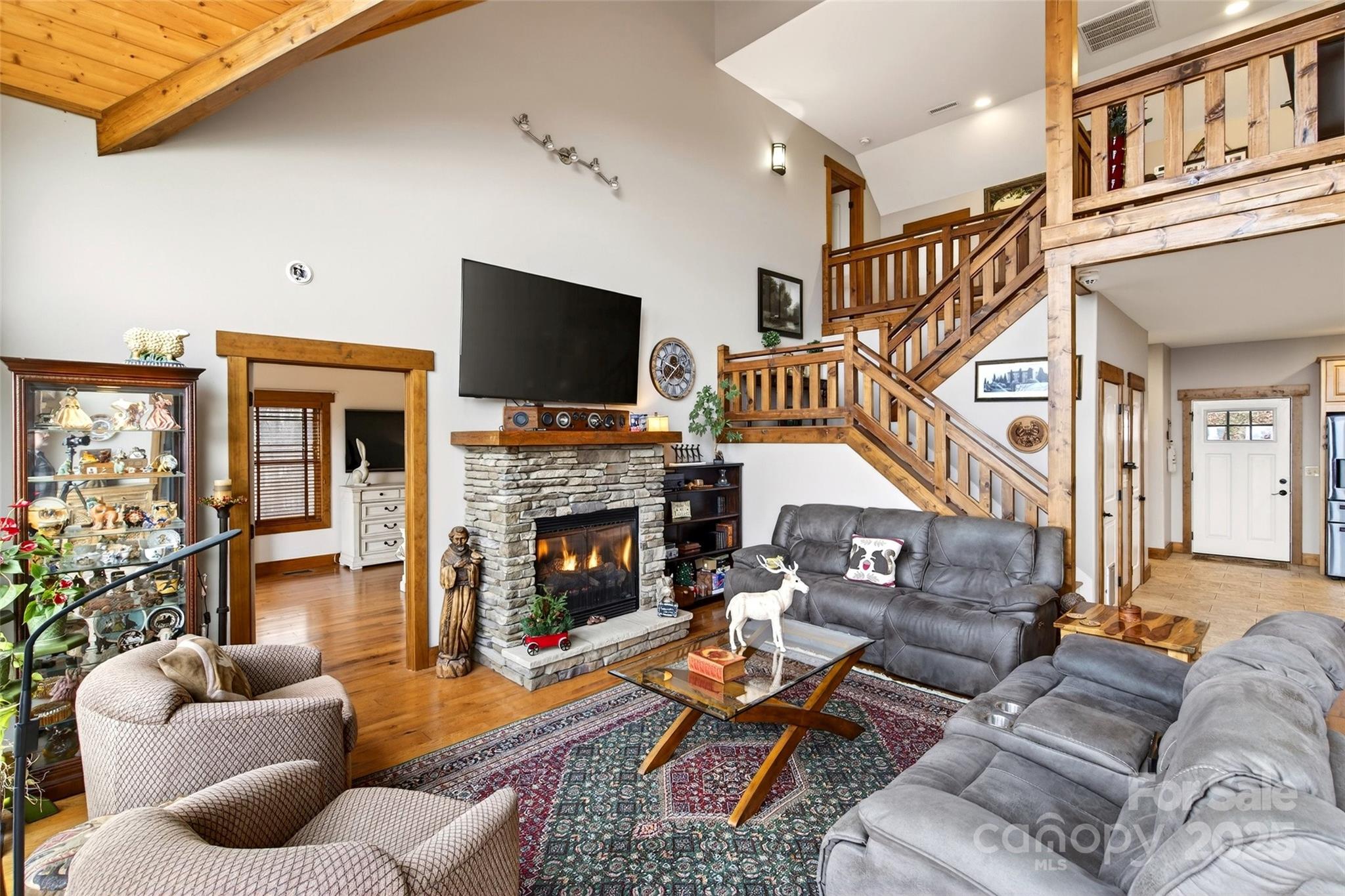 242 Lakeview Trail Nebo, NC 28761 - Photo 7 of 46 a living room with furniture a flat screen tv and a fireplace