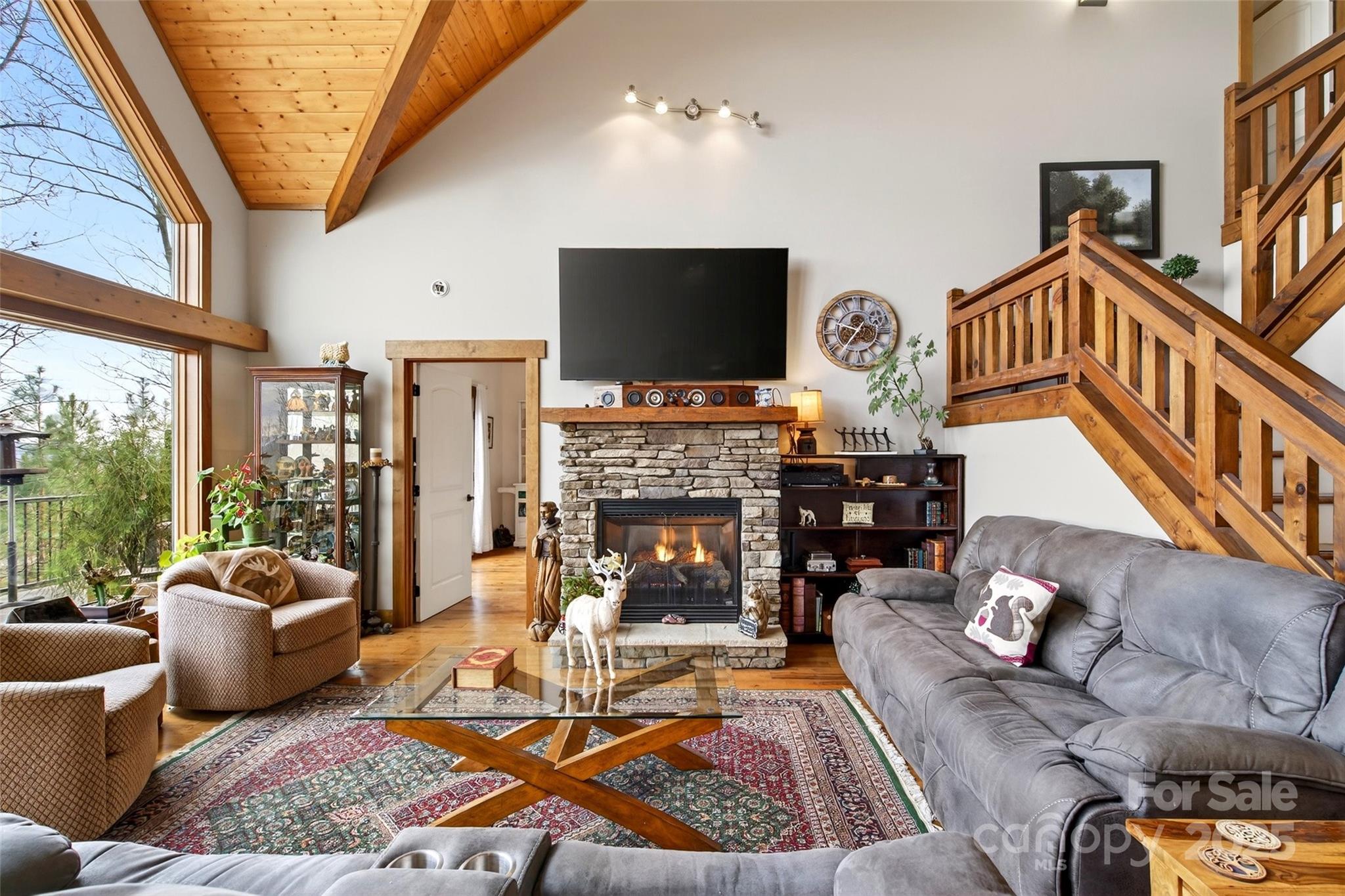 242 Lakeview Trail Nebo, NC 28761 - Photo 8 of 46 a living room with furniture a fireplace and a flat screen tv