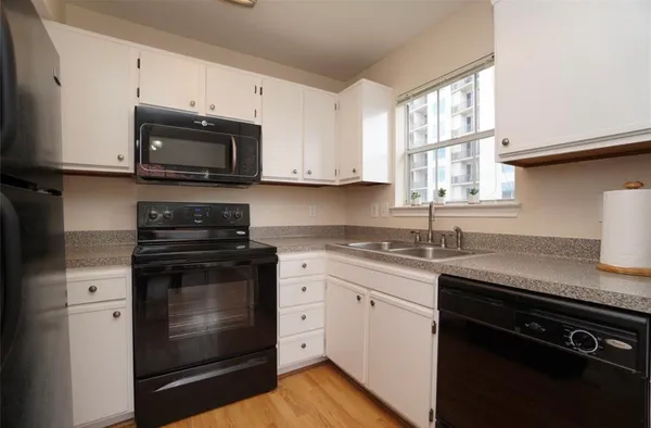 a kitchen with a sink cabinets and dining table