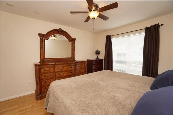a bedroom with a large bed and a chandelier