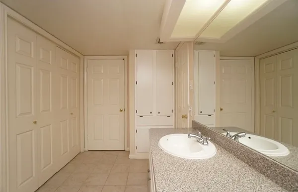 a kitchen with granite countertop a refrigerator and a sink