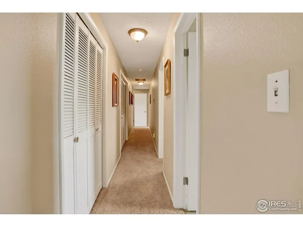 a view of a hallway with a white door