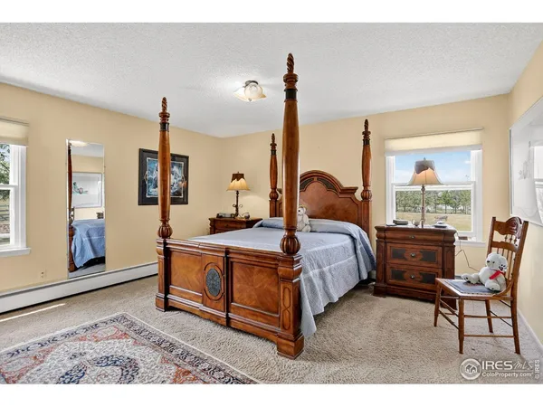 a bed room with a bed and a chair