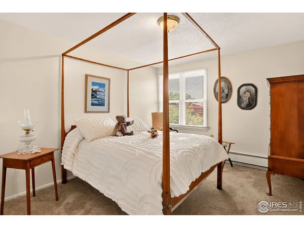 a bedroom with a bed window and a table