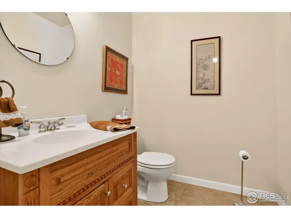 a bathroom with a sink mirror and toilet