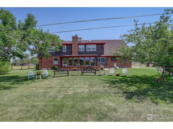 a view of a house with a yard porch and sitting area
