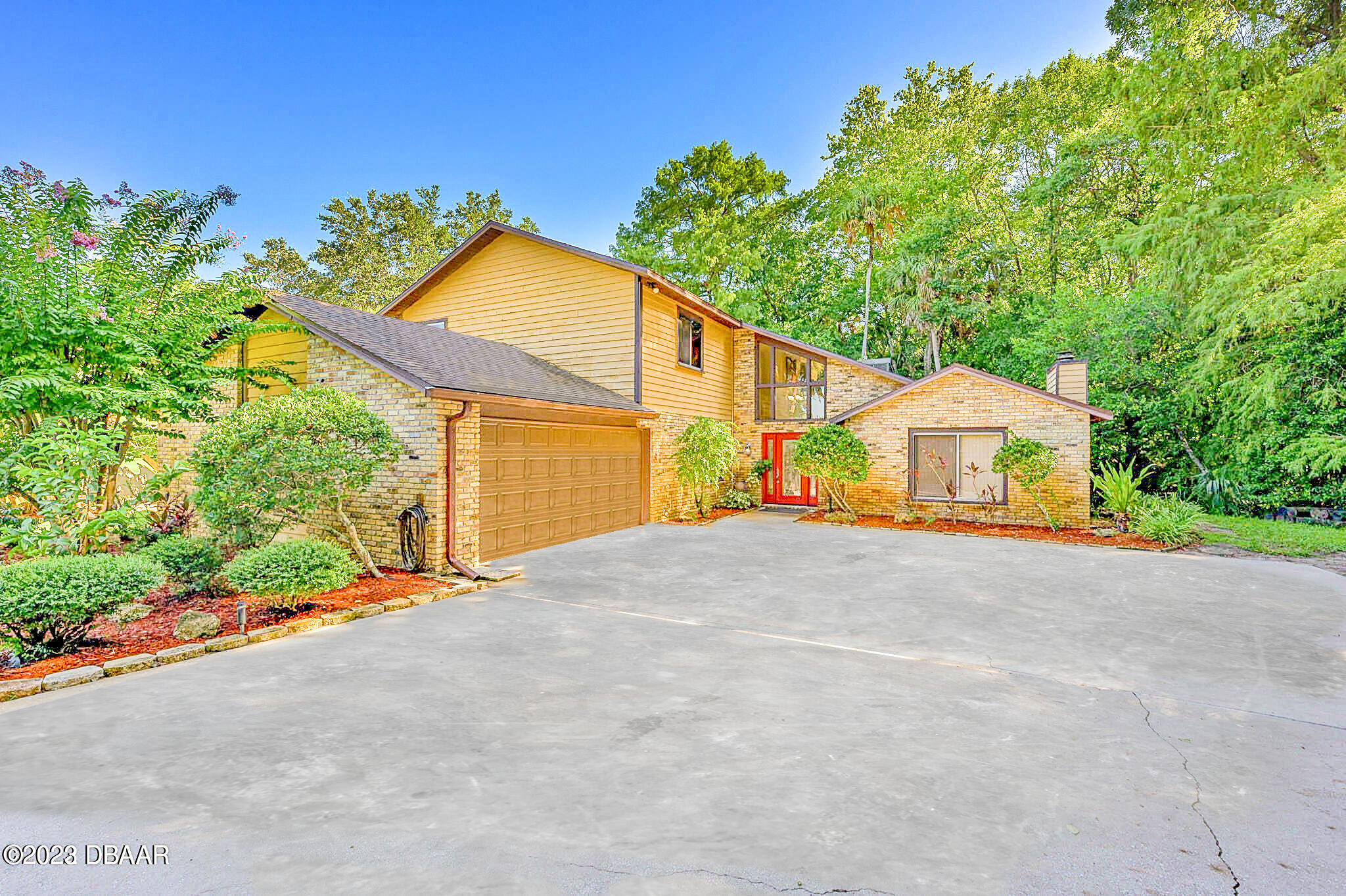 a view of backyard with plants and outdoor seating