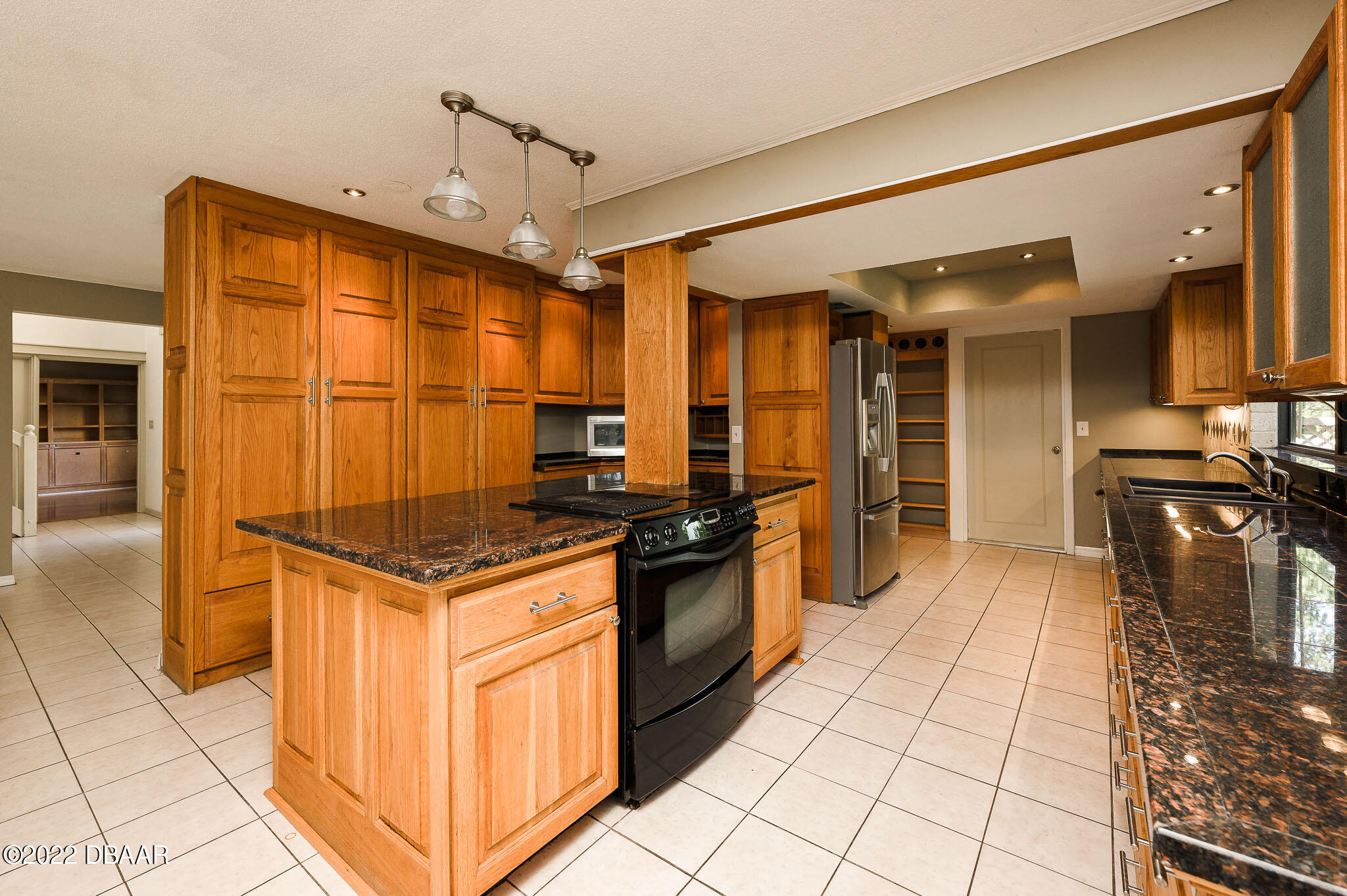 35 Pebble Beach Drive Ormond Beach, FL 32174 - Photo 14 of 45 a kitchen with stainless steel appliances granite countertop a stove and a refrigerator