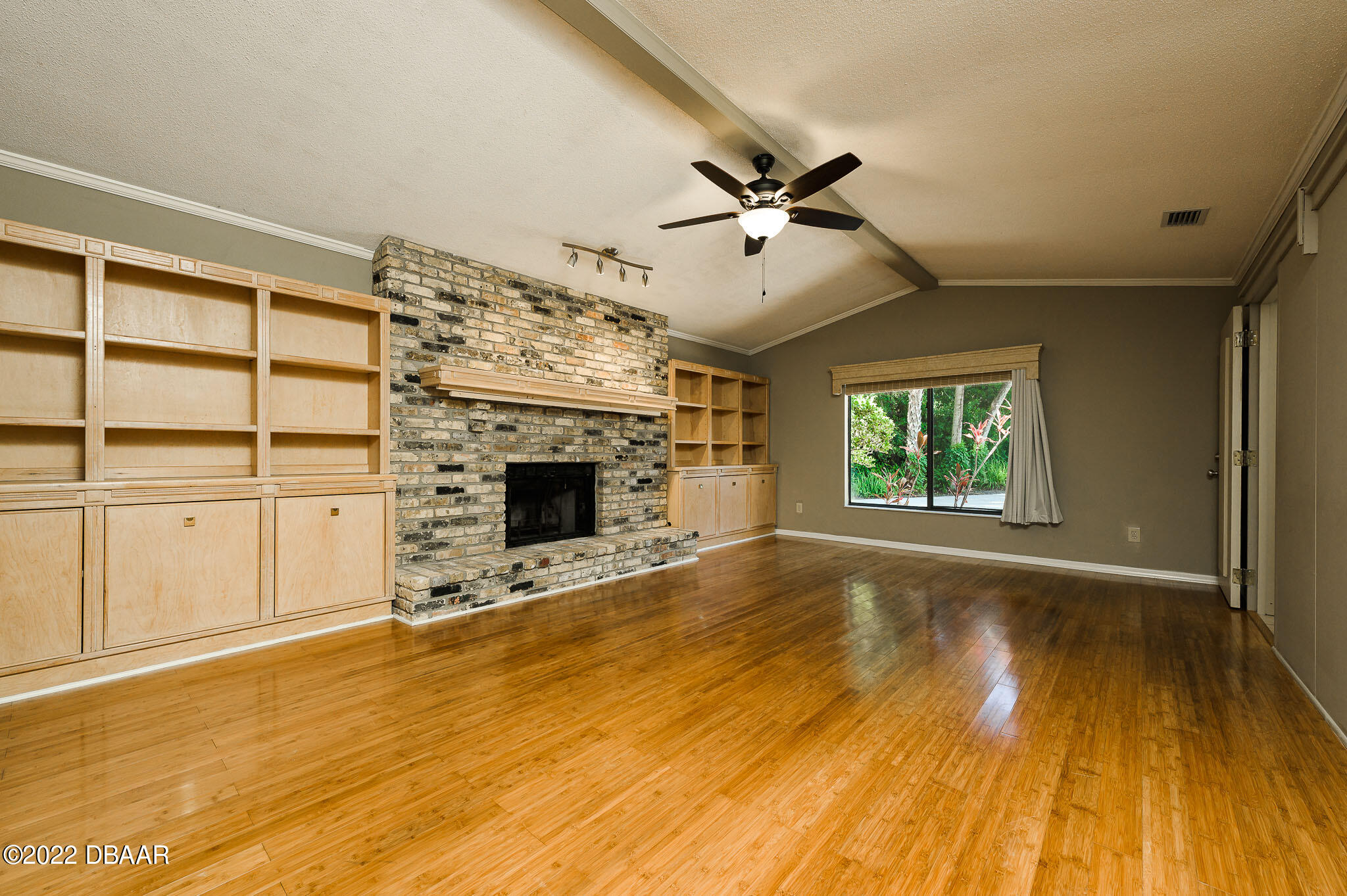 35 Pebble Beach Drive Ormond Beach, FL 32174 - Photo 18 of 45 a view of an empty room with a fireplace and a window