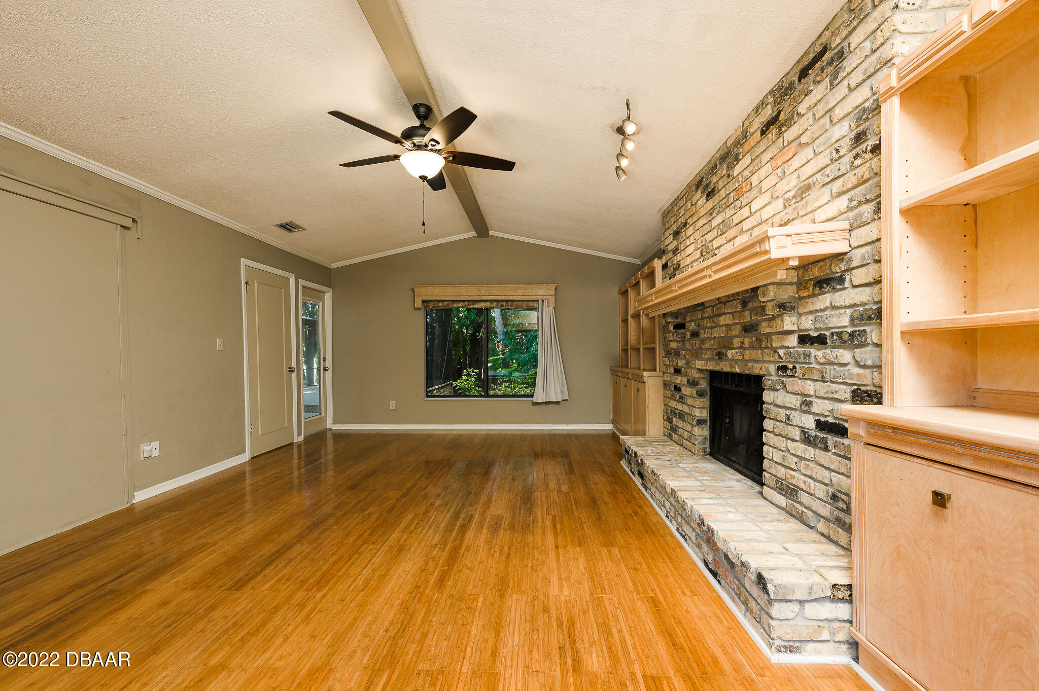 35 Pebble Beach Drive Ormond Beach, FL 32174 - Photo 19 of 45 a view of empty room with wooden floor and fireplace