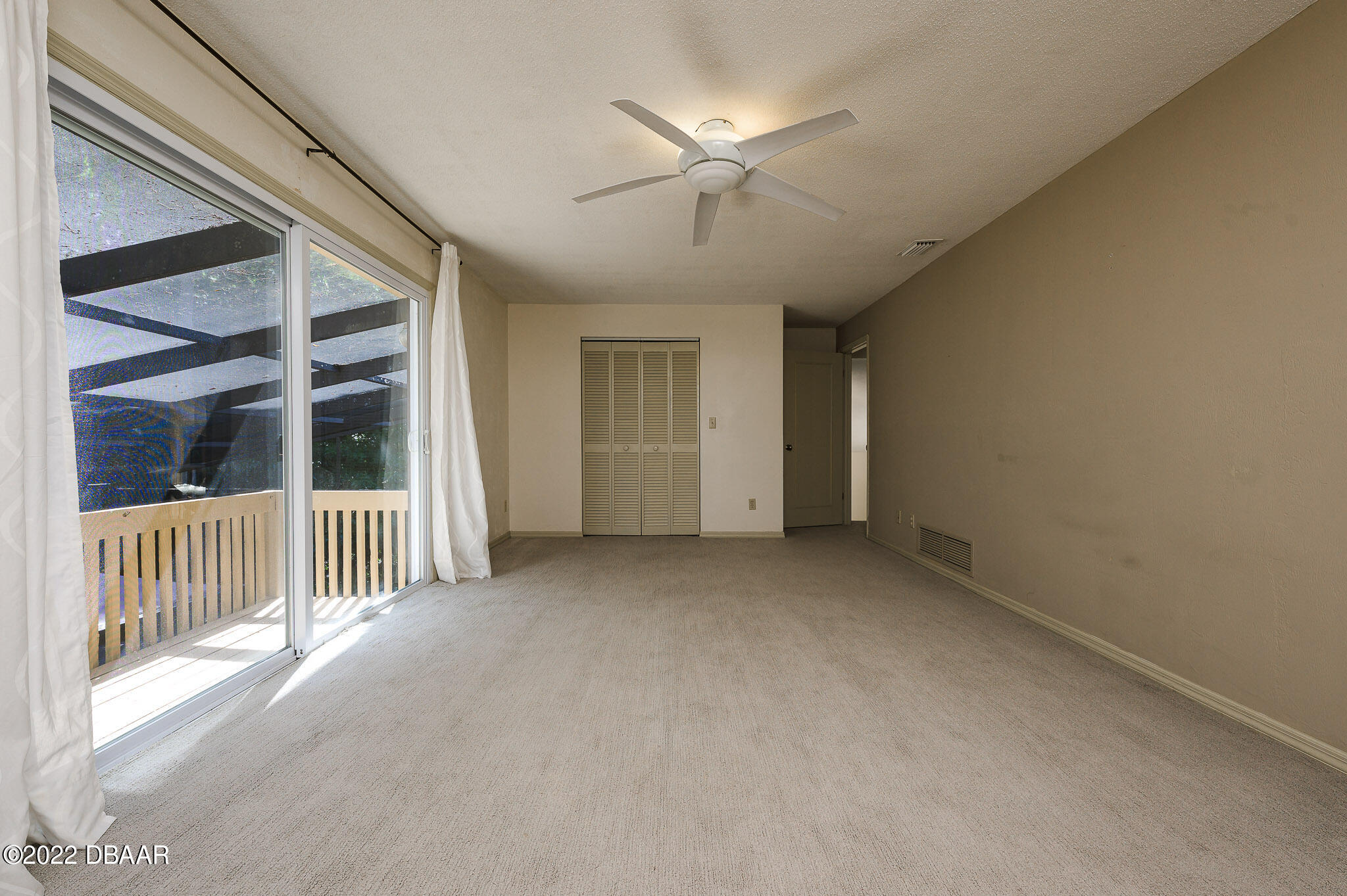 35 Pebble Beach Drive Ormond Beach, FL 32174 - Photo 22 of 45 en view interior of a house with wooden floor and ceiling fan