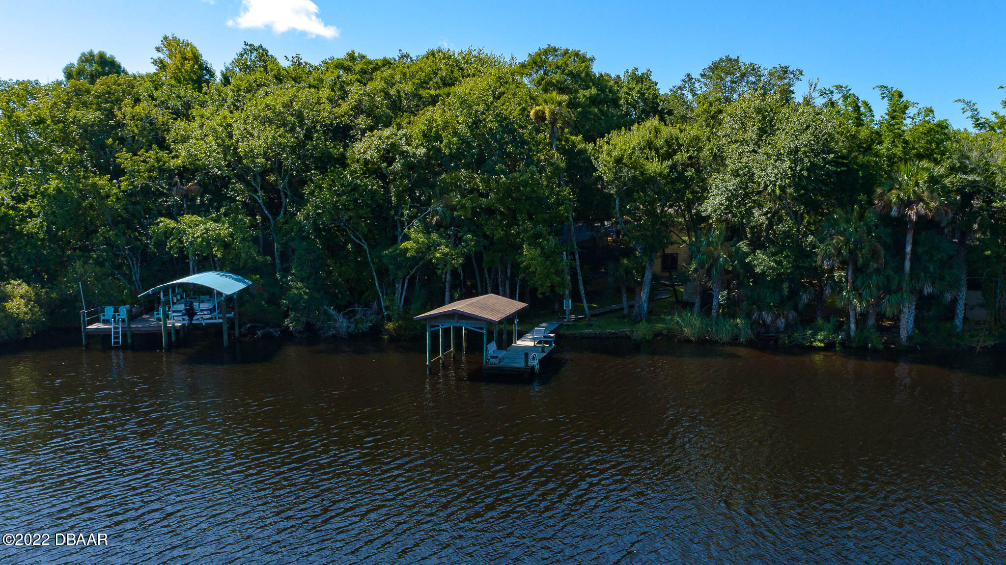 35 Pebble Beach Drive Ormond Beach, FL 32174 - Photo 3 of 45 a view of a lake with a bench