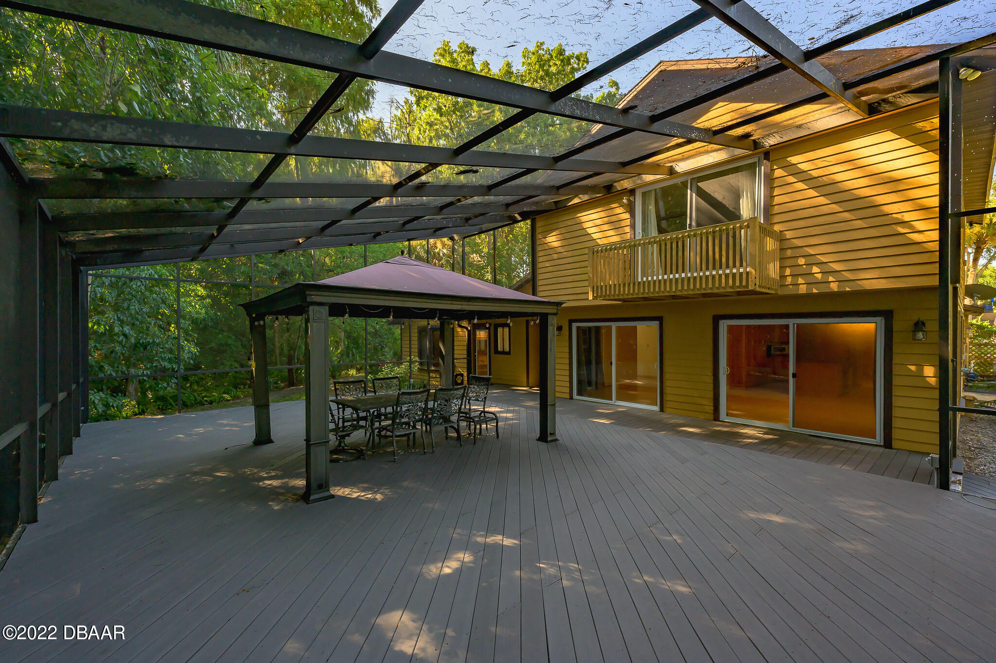 35 Pebble Beach Drive Ormond Beach, FL 32174 - Photo 32 of 45 a view of a chair and table in the back yard of the house