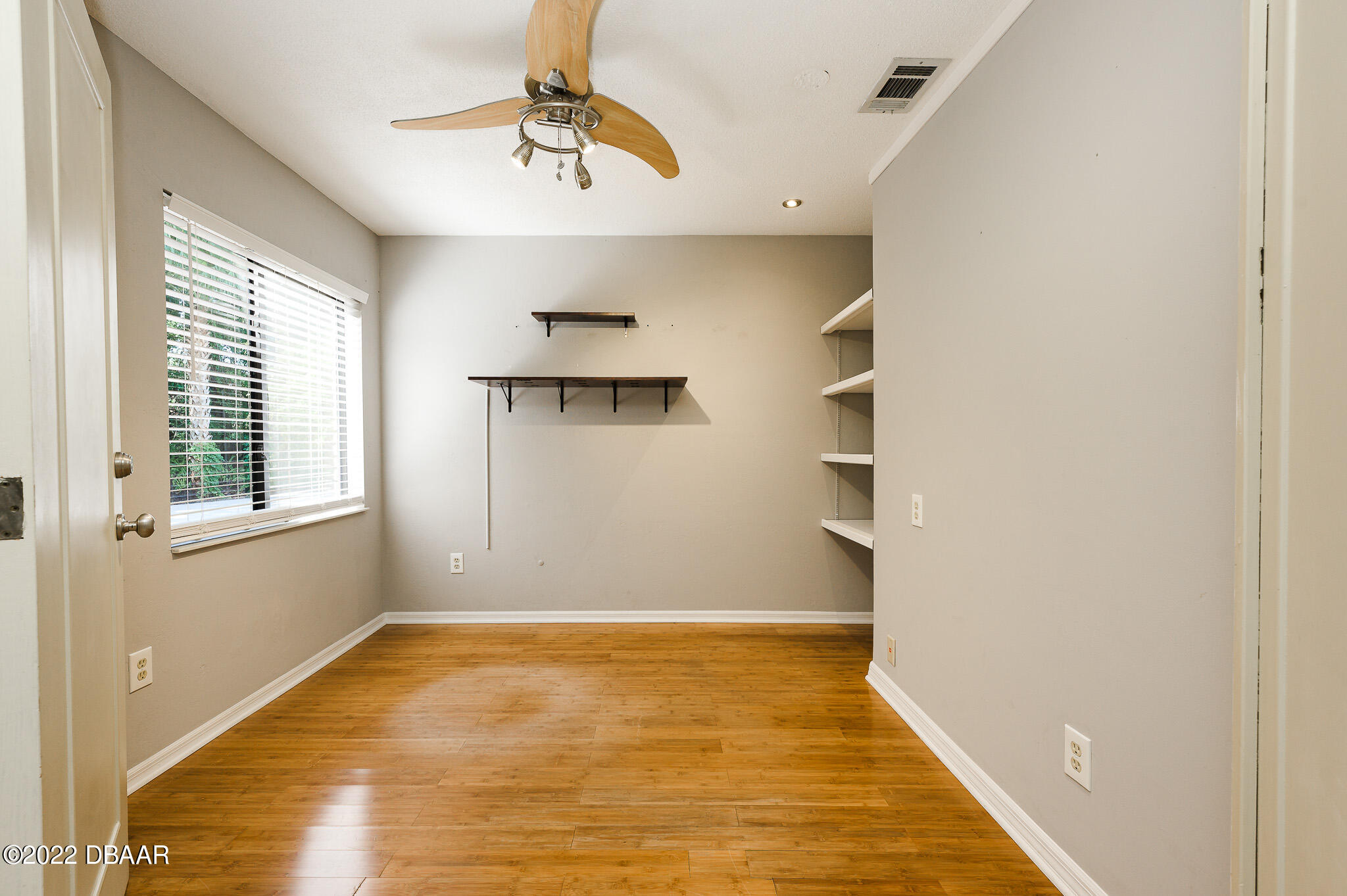 35 Pebble Beach Drive Ormond Beach, FL 32174 - Photo 10 of 45 a view of empty room with wooden floor and fan