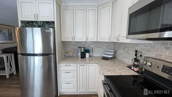 a kitchen with stainless steel appliances granite countertop a refrigerator sink and cabinets